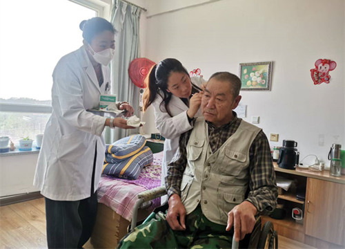 左与右耳助听器给老人义务检查耳道清理耳朵